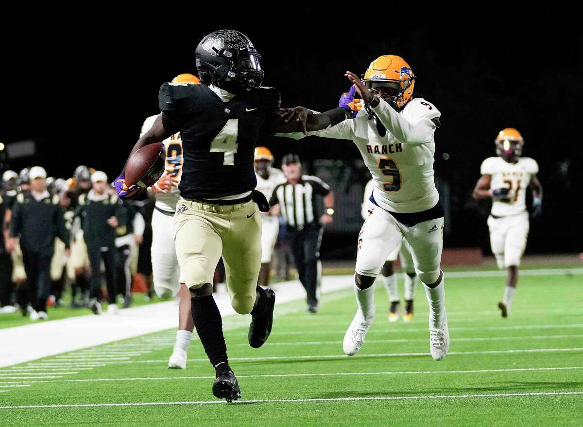 Cypress Park wide receiver Harold Perkins (4) fends off Cypress Ranch defensive back Josh Ciers (9) en route to a touchdown during the second half of a high school football game, Thursday, Oct. 28, 2021, in Cypress.