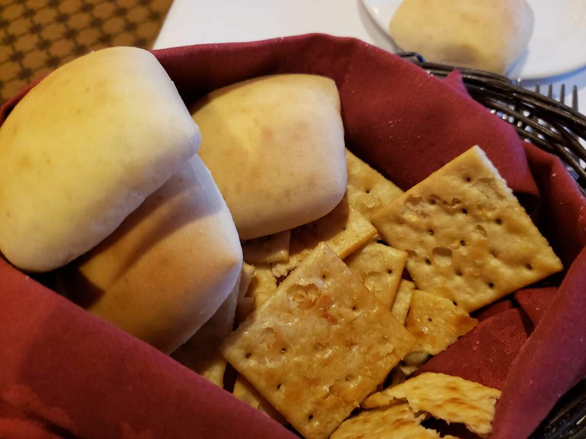 A basket of toasted saltines like you’ve never had before comes to the table accompanied by rolls and butter at the Idle Hour Club in Macon, GA.
