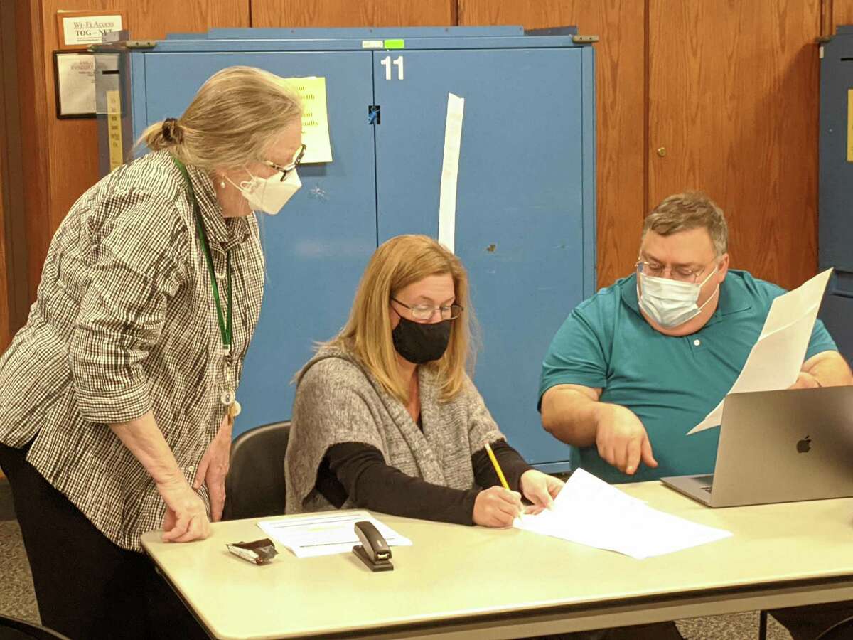 From left, Democratic Registrar of Voters Mary Hegarty, Assistant Town Clerk Kimberly Spezzano and Republican Registrar Fred DeCaro work on the recount last week for a school board seat. Certified results this week now show that Republican Cody Kittle is the winner — by 13 votes — over Megan Galletta.