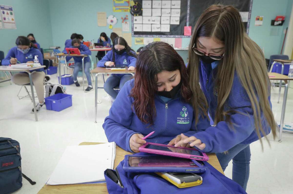 Amigos Por Vida-Friends For Life Public Charter School 8th-graders Veronica Prado (left) and Ashley Argueta work on a math problem in Mr. Mario Hernandez's class Friday, Nov. 20, 2020, in Houston.