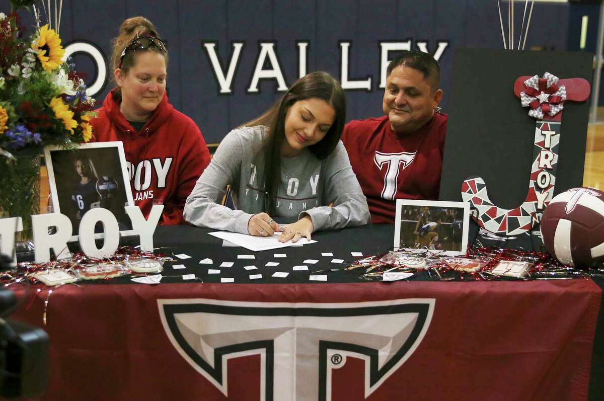 Senior Jaci Mesa signs her intent to play volleyball for Troy University as she participates with 13 other Smithson Valley students gathered with classmates to celebrate college signing day on Wednesday, Nov. 10, 2021.