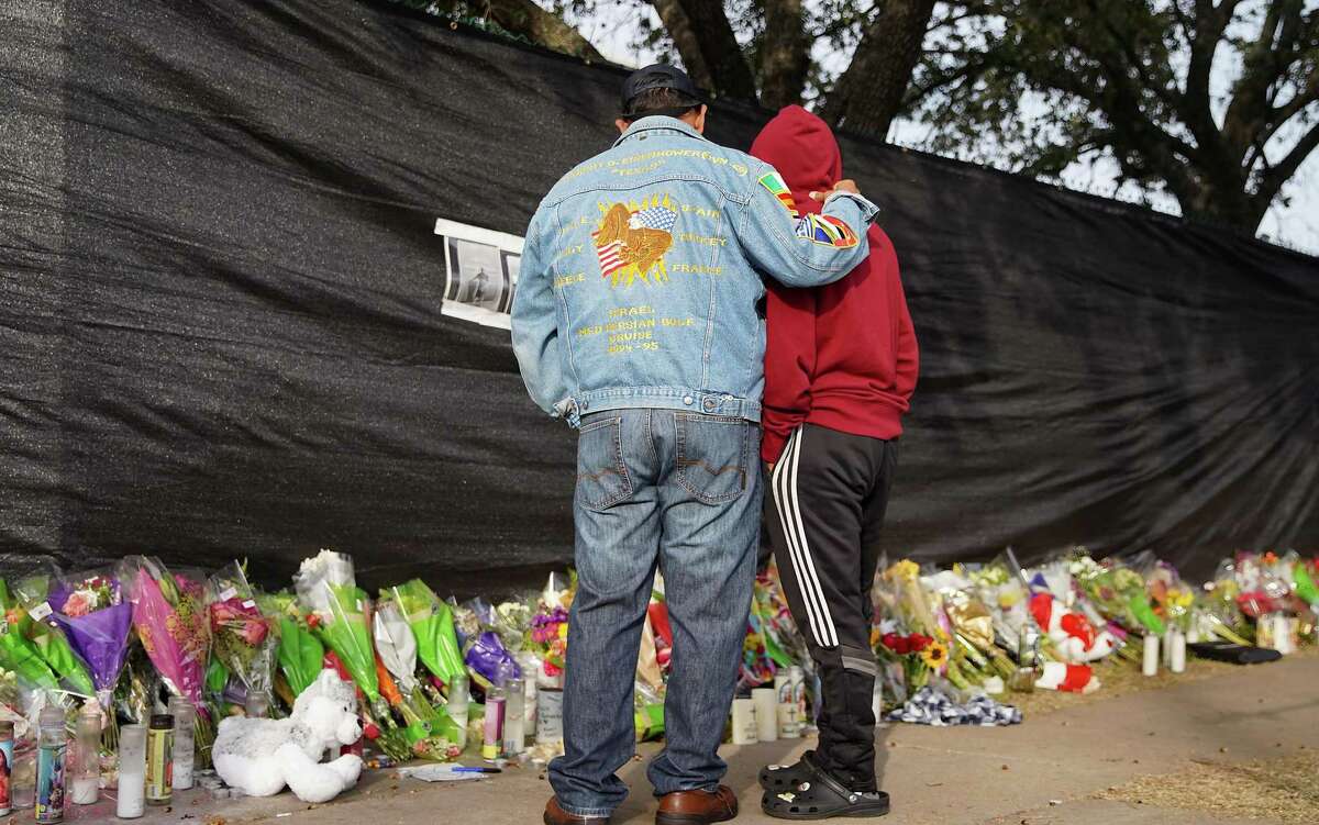 Mourners take in the make-shift memorial at Westridge and Kirby, in honor of the victims of the tragedy at last weekend’s Astroworld Festival on Tuesday, Nov. 9, 2021 in Houston. Eight people died and multiple people were injured after the crowd surged during Travis Scott’s concert.