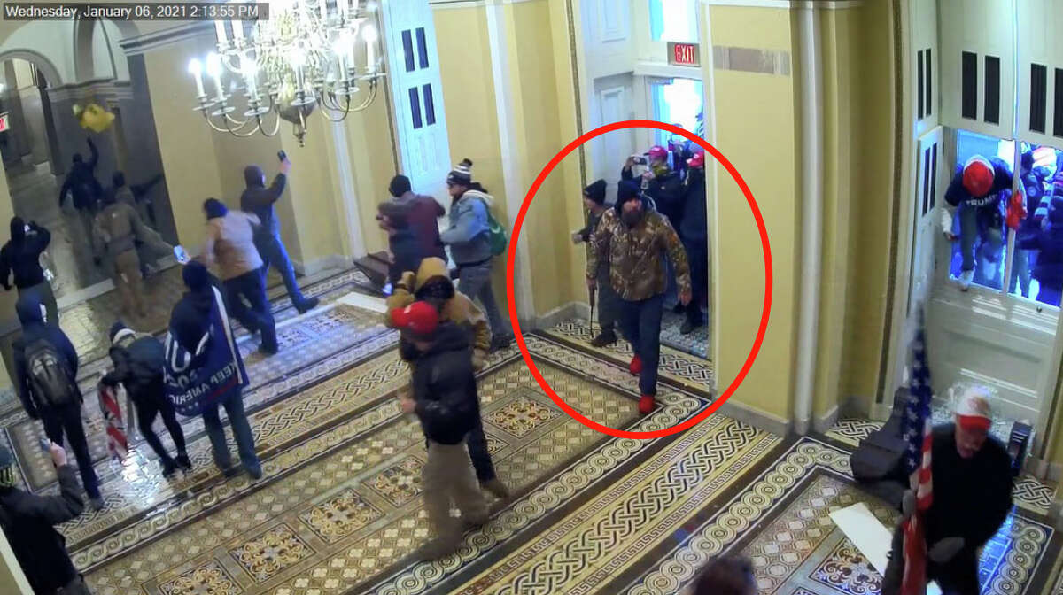 Prosecutors say this video still from Capitol surveillance camera shows Scott Fairlamb, circled by law enforcement, carrying a collapsible baton taken from police officers, entering the U.S. Capitol on Jan. 6. (Image from sentencing documents submitted to United States District Court for the District of Columbia)