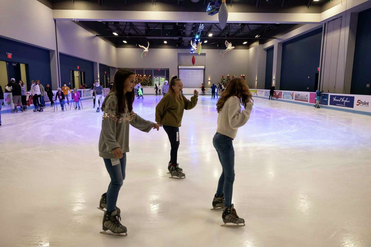 Visitors skate at the ice rink at Cynthia Woods Mitchell Pavilion in Town Center, Tuesday, Dec. 29, 2020, in The Woodlands.
