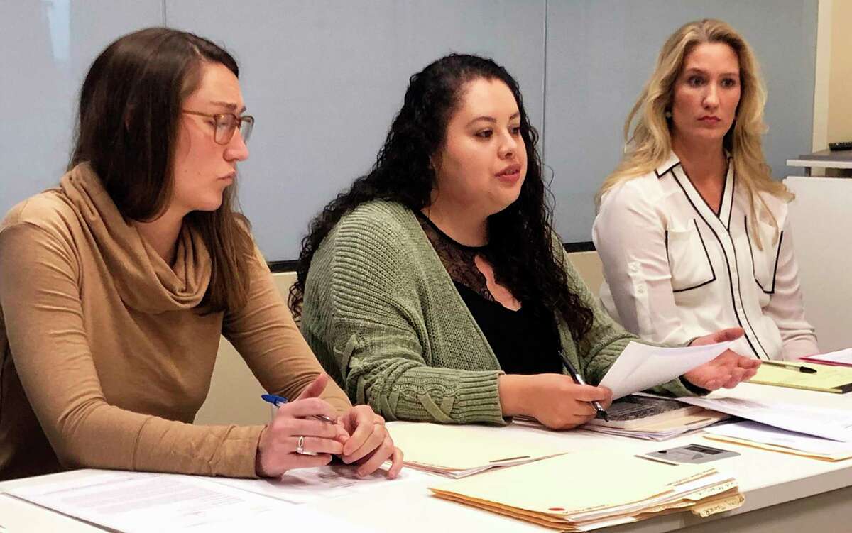 The Tarrant County Domestic Violence High Risk Team -- made up of police, prosecutors, social workers, victim advocates and others -- tries to identify and protect women at high risk of being killed by their abusers. Dennise Espeleta, center, leads a meeting of the group.