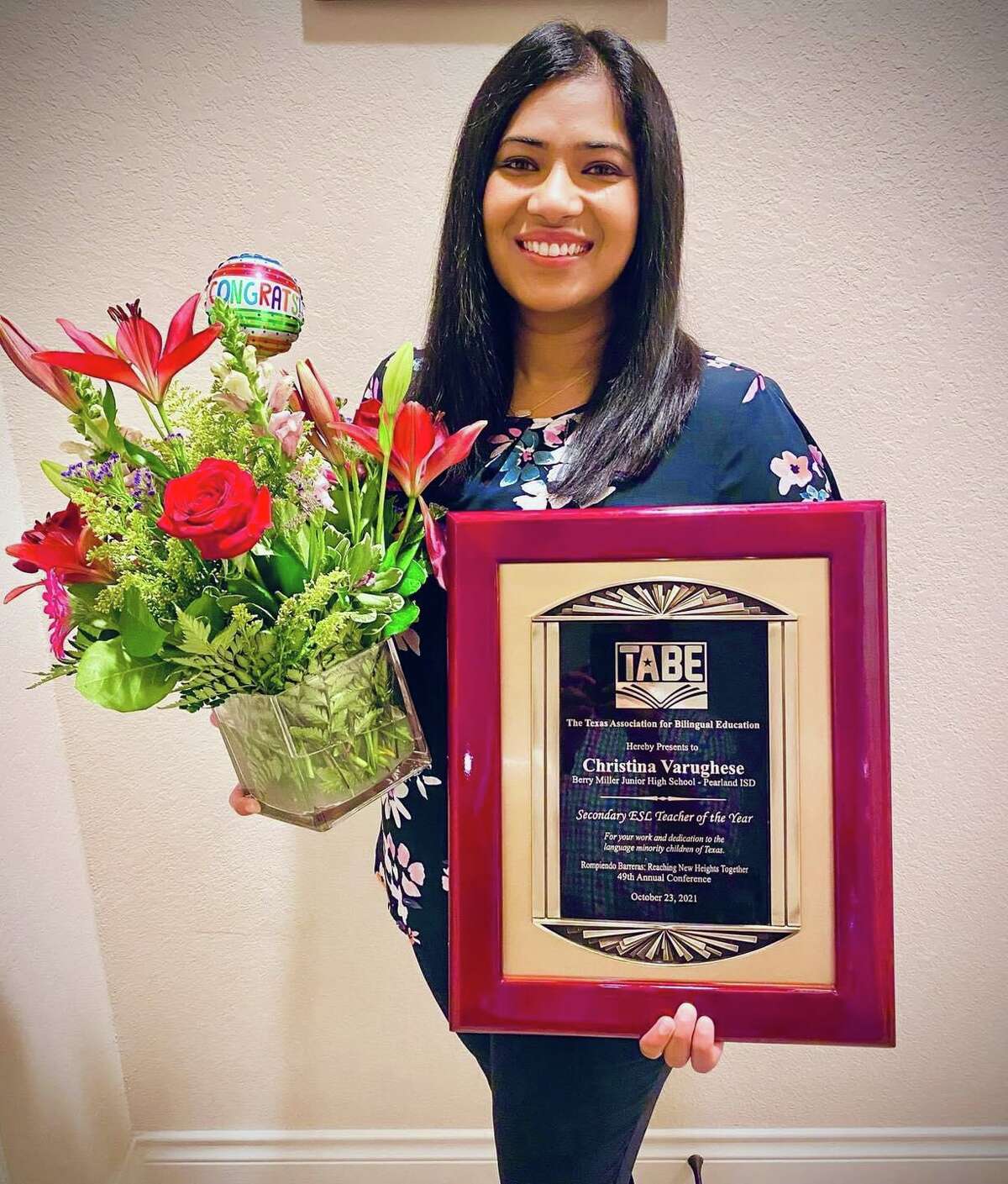 Berry Miller Junior High School’s Christina Varughese holds a congratulatory bouquet and plaque recognizing her selection as 2021 Bilingual/ESL Secondary Teacher of the Year.