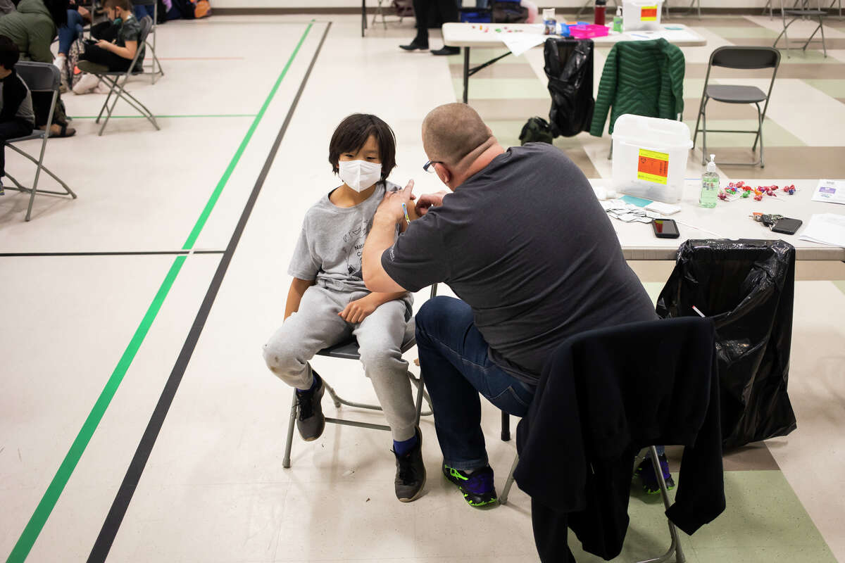 Jun Park, 10, receives the Pfizer-BioNTech COVID-19 vaccination during a vaccine clinic for children from ages 5 - 11 Wednesday, Nov. 10, 2021 at Siebert Elementary in Midland. (Katy Kildee/Midland Daily News)
