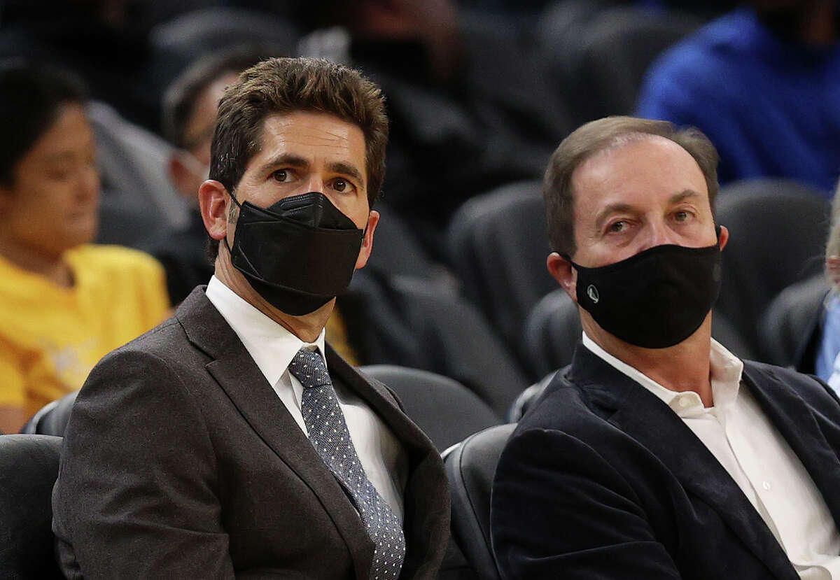 Golden State Warriors general manager Bob Myers and owner Joe Lacob watch their team play the Denver Nuggets at Chase Center on Oct. 6, 2021, in San Francisco.