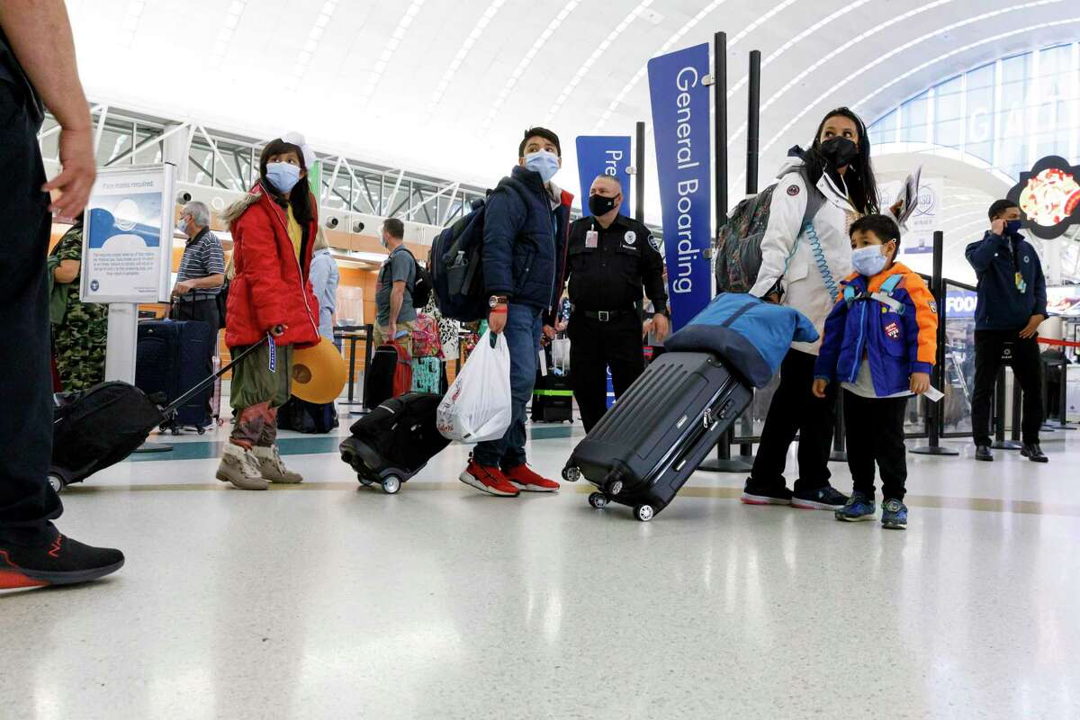 A family makes its way toward the security screening line in Terminal A at San Antonio International Airport on Nov. 10. The number of people flying during the winter holiday season is projected to be up 177 percent over last year, according to AAA Texas.
