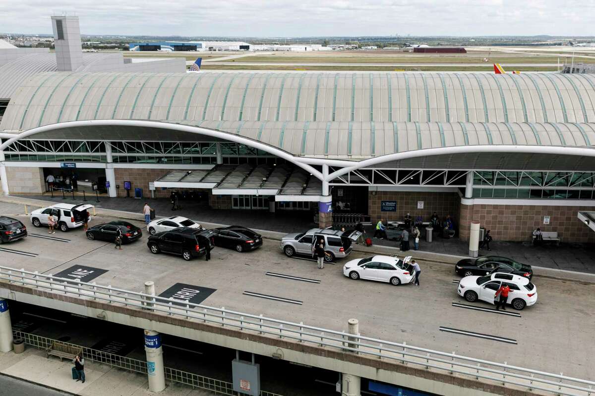 People arrive to Terminal A to catch their flights at the San Antonio International Airport.