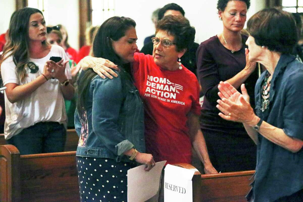 Rena Castro is consoled by Linda Wilson, right, after delivering an emotional account of the killing of her daughter Erin, 19, by a boyfriend in 2018. The mother spoke during a town hall on family violence on July 2, 2019.