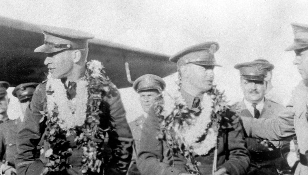 Lt. Lester Maitland (left) and his navigator, Lt. Albert Hagenberger, stand with other military personnel following the first trans-Pacific flight in June 1927. The flight ran 2,416 miles and took 26 hours and 49 minutes to complete. Air Force photo.