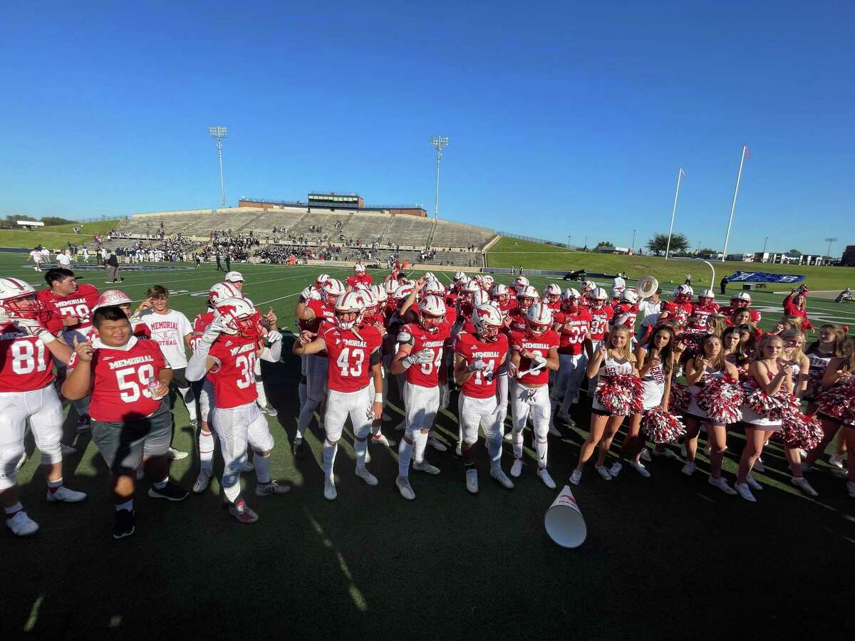 The Memorial Mustang football players and cheerleaders celebrate in front of their fans following a 28-10 win over Cy Ridge at Tully Stadium on Saturday, Nov. 6, 2021.