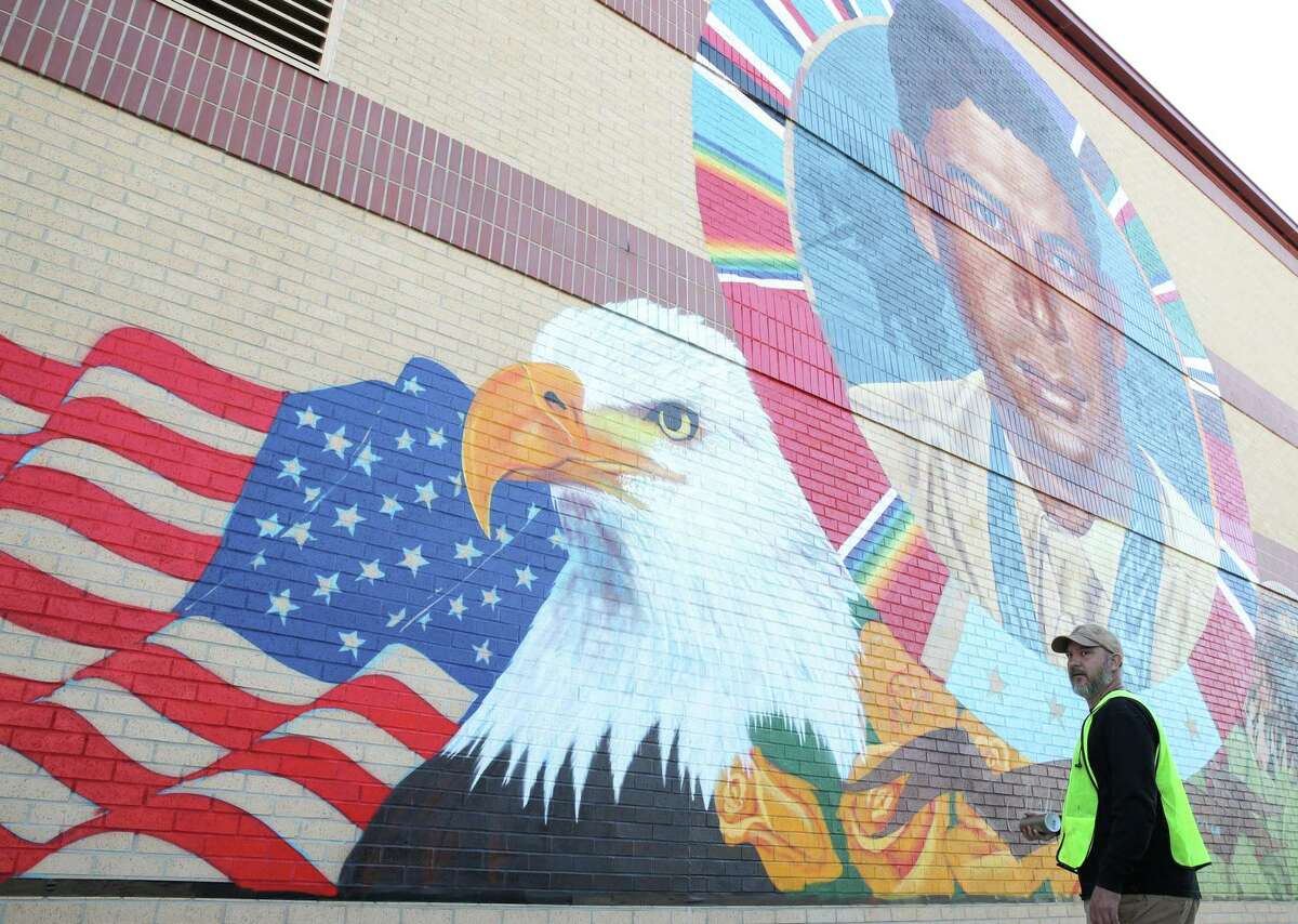 Artist Mez Data works on a mural of Staff Sgt. Macario García on Monday, Nov. 8, 2021, at Houston Fire Department Station 20, at the intersection of Navigation Boulevard and Staff Sgt. Macario Garcia Drive in Houston.