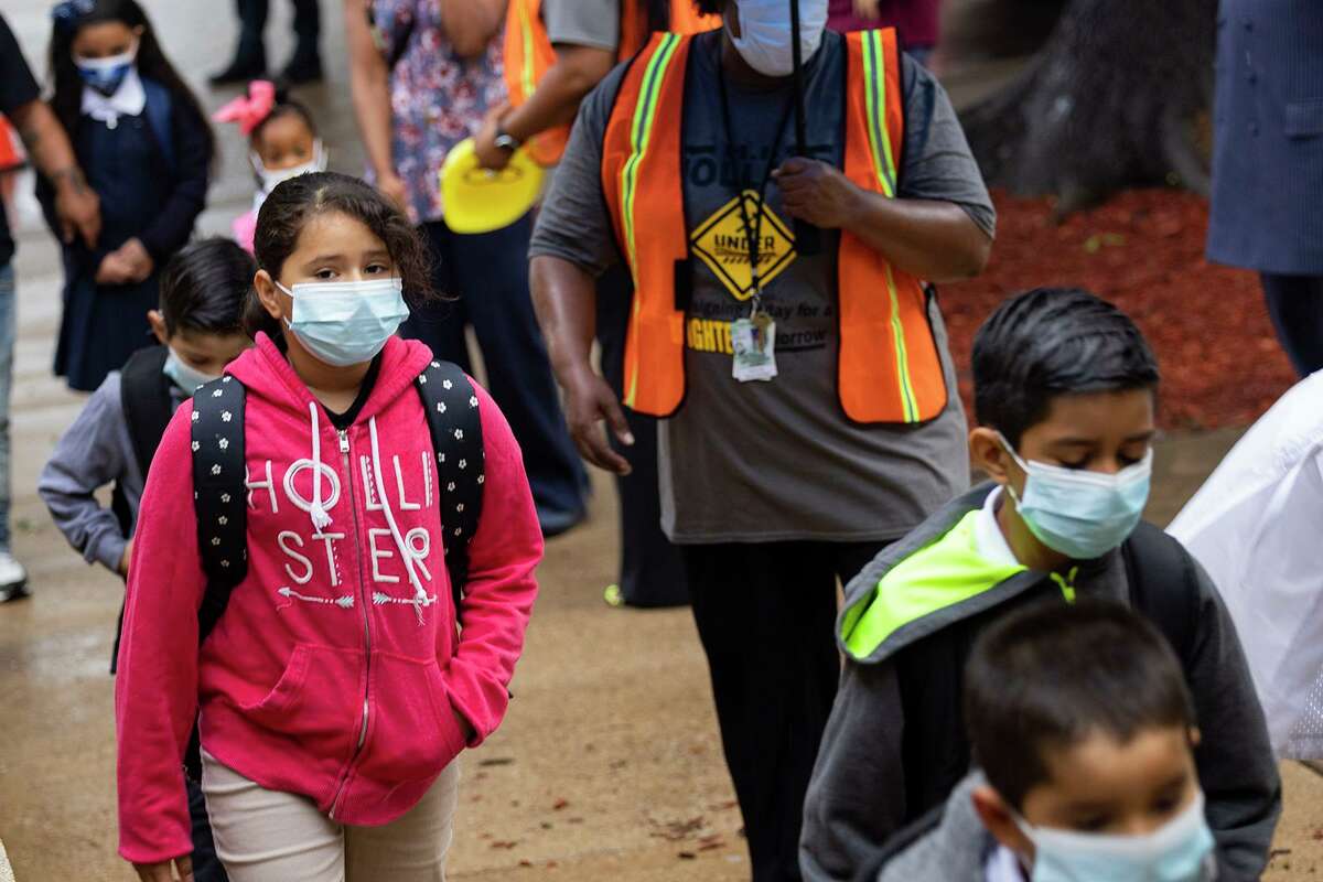 Students wear masks as they head into the first day of school on Monday, Aug. 2, 2021, at H.I. Holland Elementary School in Dallas. (Juan Figueroa/Dallas Morning News/TNS)