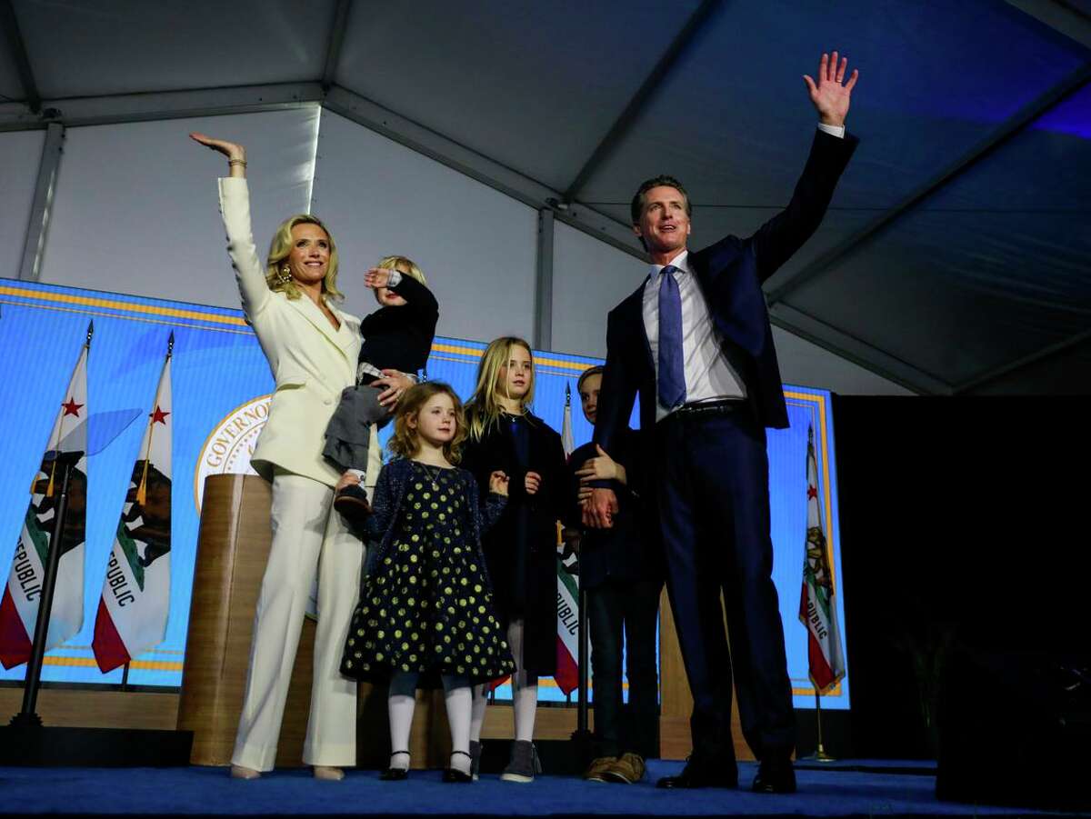 Gov. Gavin Newsom, wife Jennifer Siebel Newsom and their children wave to the crowd at his inauguration ceremony in Sacramento in January 2019.