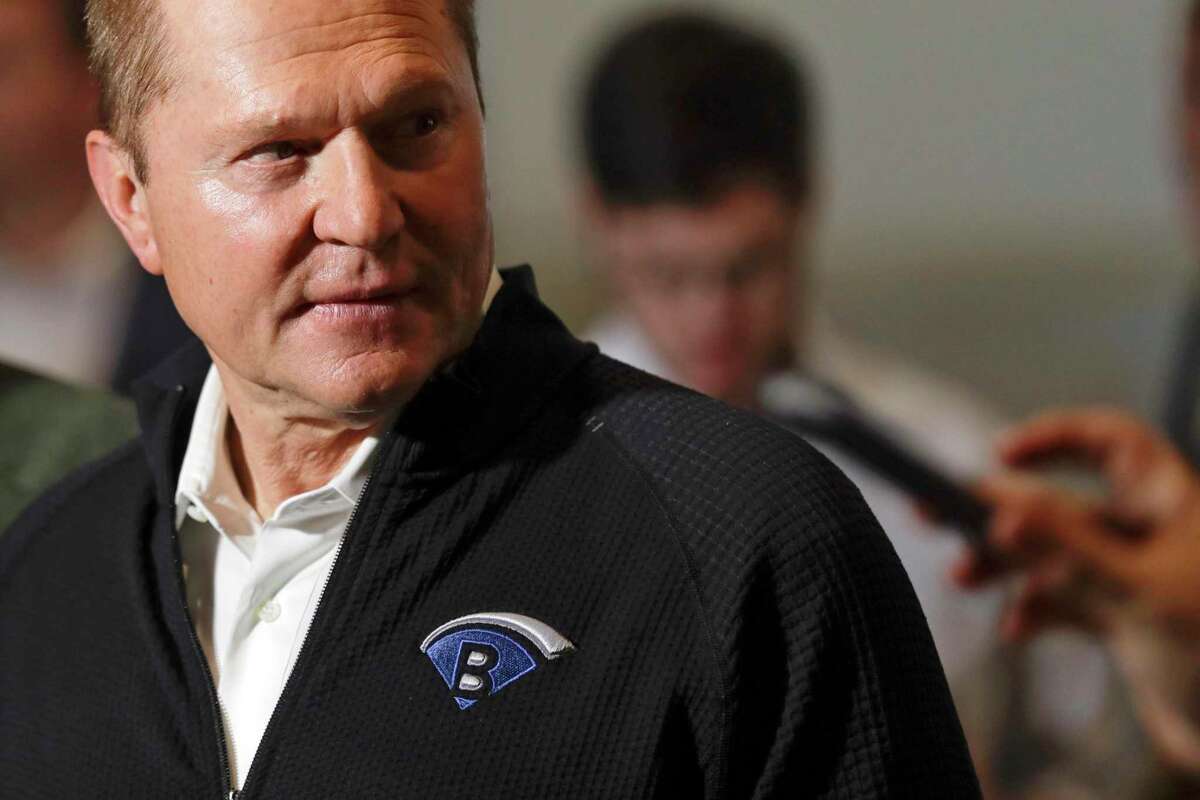 FILE - Sports agent Scott Boras, wearing a jacket with his personal logo, speaks at the Major League Baseball winter meetings in San Diego on Dec. 10, 2019. Boras, baseball’s most influential agent said the sport was the victim of a “competitive cancer” caused by teams unloading veterans to accumulate draft picks and said the Atlanta Braves’ World Series title was a direct result of tanking. (AP Photo/Gregory Bull, File)