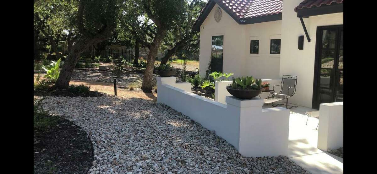 Live oaks, wildflowers, pathways make front yard of Garden Ridge home a relaxing retreat.