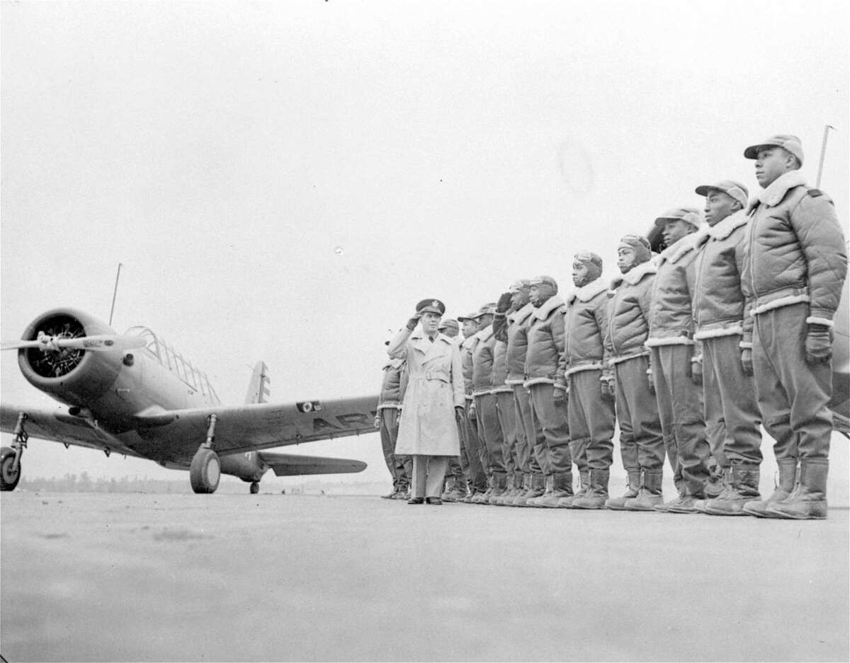 FILE - Major James A. Ellison, left, returns the salute of Mac Ross of Dayton, Ohio, as he inspects the cadets at the Basic and Advanced Flying School for Black United States Army Air Corps cadets at the Tuskegee Institute in Tuskegee, Ala., in Jan. 23, 1942. For Veterans Day, a group of Democratic lawmakers is reviving an effort to pay the families of Black servicemen who fought on behalf of the nation during World War II for benefits they were denied or prevented from taking full advantage of when they returned home from war.
