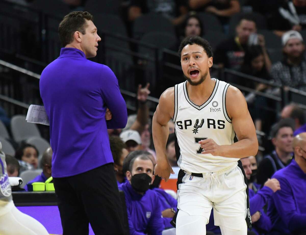 Bryn Forbes of the San Antonio Spurs reacts as he runs by oppoing coach Luke Walton after making a three-point shot against the Sacramento Kings during second-half NBA action in the AT&T Center on Wednesday, Nov. 10, 2021.