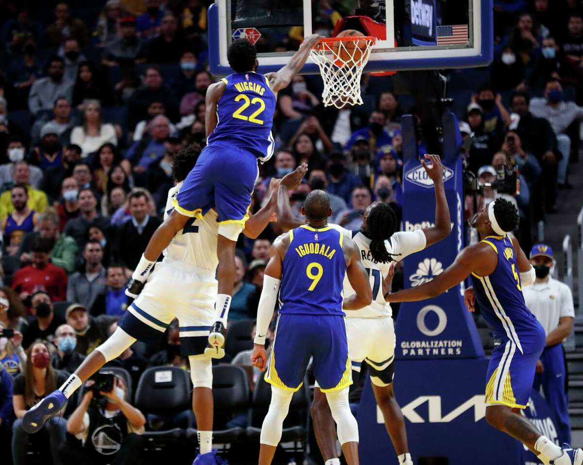 Andrew Wiggins launches over Karl-Anthony Towns in the fourth quarter. The Warriors, riding an eight-game homestand, have won six straight.