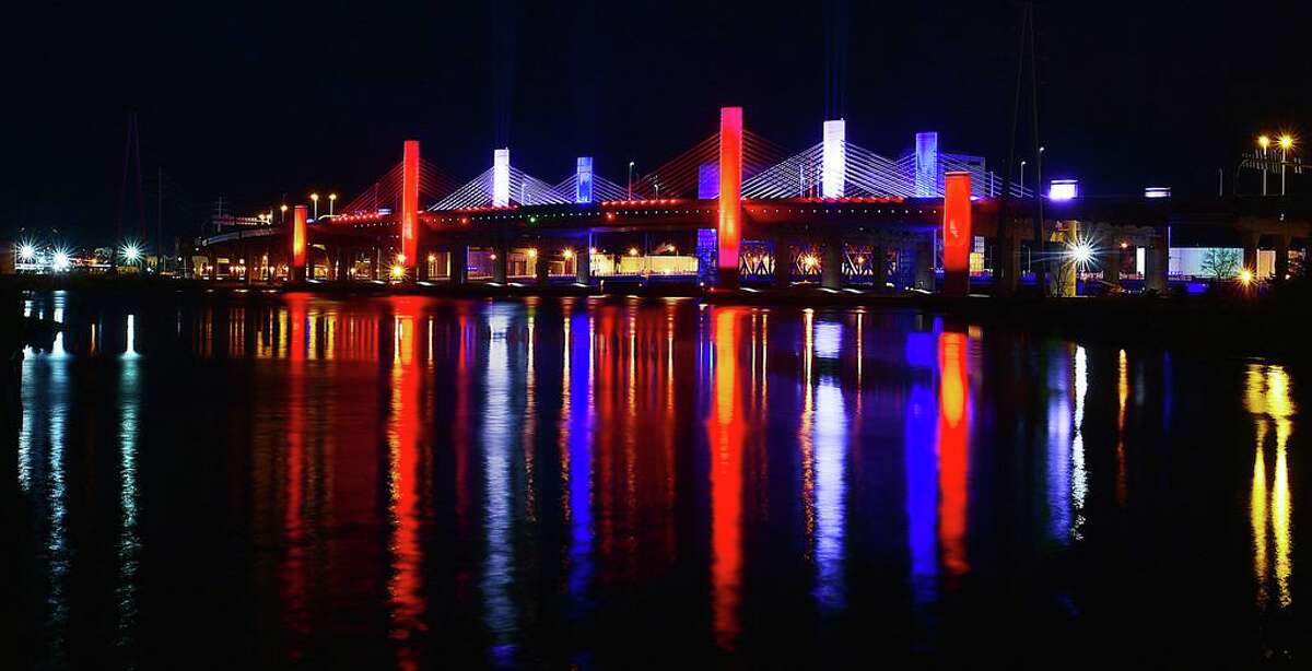 The Pearl Harbor Memorial Bridge in New Haven, resembles a battleship, illuminates the sky in the patriotic colors of red, white and blue, in 2017. It commemorates the surprise attack on the United States Naval Base at Pearl Harbor on Dec. 7, 1941. The attack killed more than 2,300 Americans and destroyed the American battleship U.S.S. Arizona and capsized the U.S.S. Oklahoma. President Franklin Delano Roosevelt called Dec. 7, 1941, “a date which will live in infamy.”