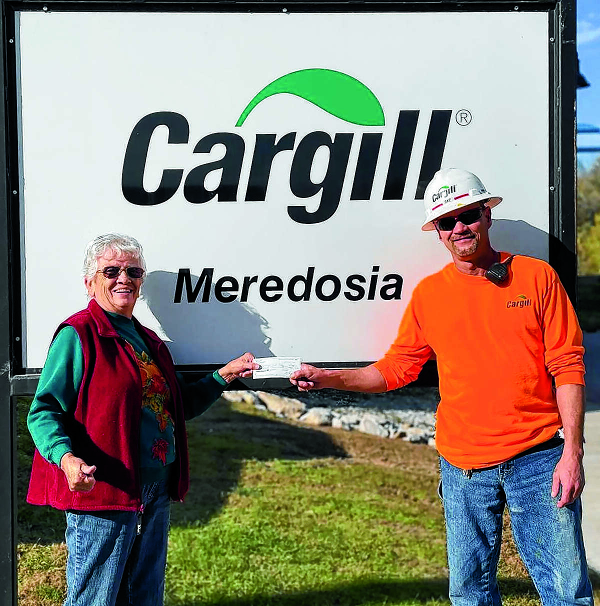 Sean Englebrecht (right) of Cargill in Meredosia presents a $3,000 check to Carol Ruyle of the Meredosia Food Pantry to help the pantry with its goal of providing food for those in need in the community.