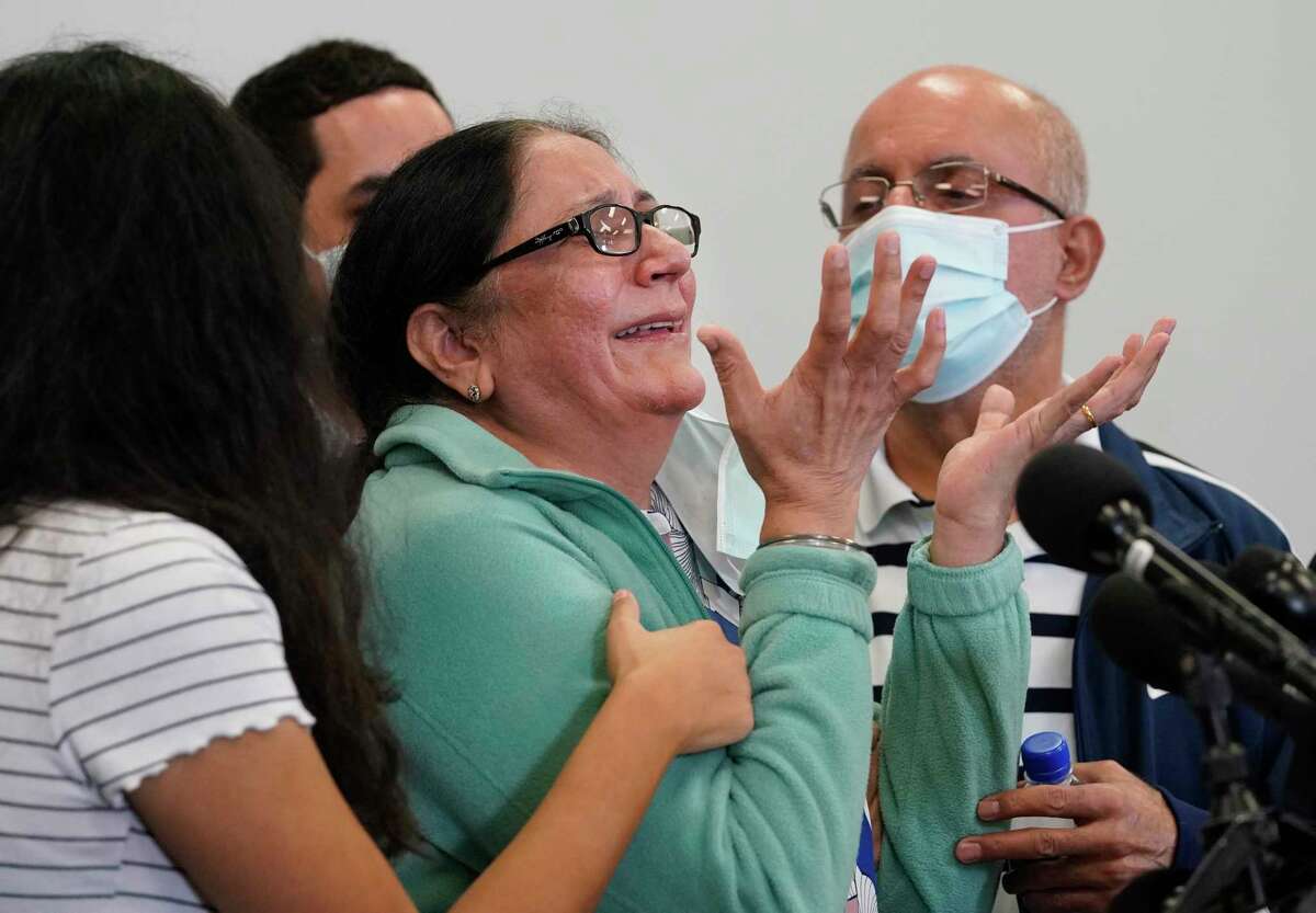 Karishma Shahani, center, is comforted by her daughter, Namrata Shahani, left, and husband, Bhagu “Sunny” Shahani, right, as she speaks about her daughter, Bharti Shahani, during a news conference at the Lassiter Law Firm, 3120 Southwest Freeway, Thursday, Nov. 11, 2021 in Houston. Bharti Shahani, who attended the Astroworld Festival has been declared dead, her family said Thursday. She remains on a ventilator and will have organs donated, the family said at the news conference.