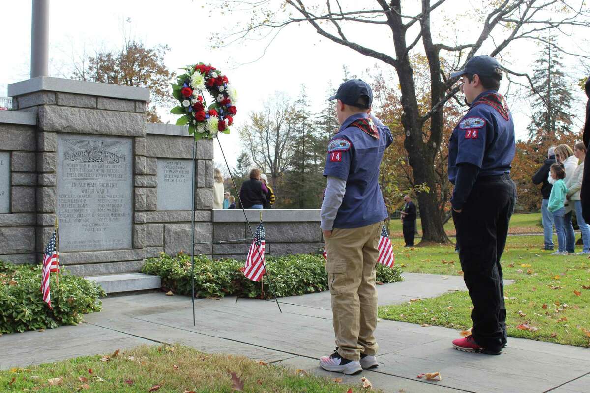 Troop 74 Boy Scouts Max Goralnick and Miles Olsen salute the wreath at the foot of the Veterans Memorial Monument at Lounsbury House during Ridgefield’s Veterans Day ceremony. Thursday, Nov. 11, 2021.