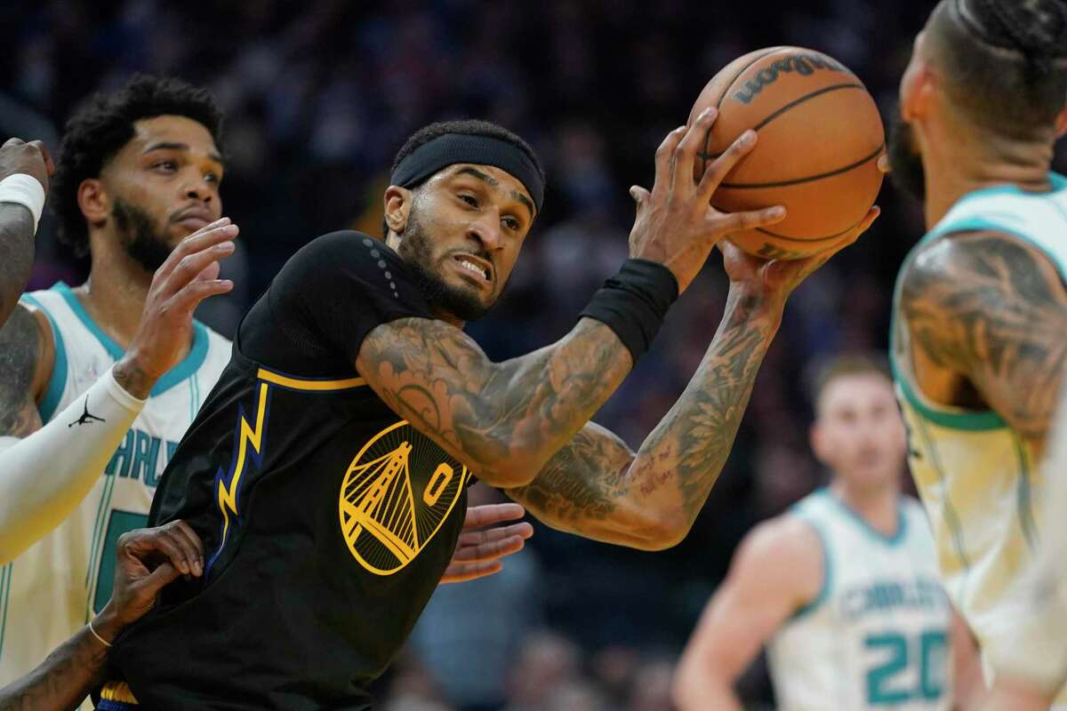Golden State Warriors guard Gary Payton II (0) is defended by Charlotte Hornets forward Miles Bridges during an NBA basketball game in San Francisco, Wednesday, Nov. 3, 2021. (AP Photo/Jeff Chiu)