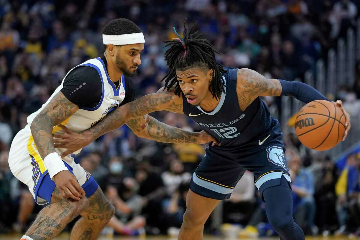 Memphis Grizzlies guard Ja Morant (12) is defended by Golden State Warriors guard Gary Payton II during an NBA basketball game in San Francisco, Thursday, Oct. 28, 2021. (AP Photo/Jeff Chiu)