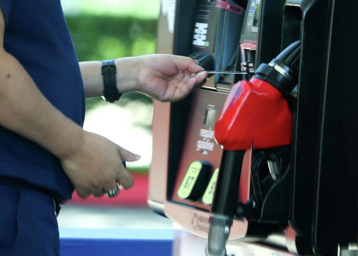 A person pays for gasoline in Houston on Monday, Oct. 11, 2021. Energy prices rose 59 percent last year, the most of any commodity, as the economic recovery from the global pandemic boosted demand for crude and petroleum products. 