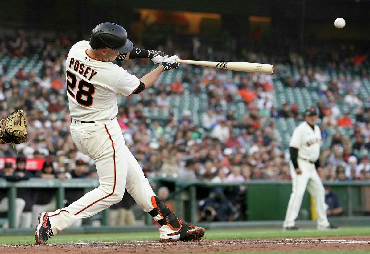 Buster Posey (28) of the San Francisco Giants hits a three-run home run against the Arizona Diamondbacks in the bottom of the first inning at Oracle Park on June 16, 2021 in San Francisco, California. (Thearon W. Henderson/Getty Images/TNS)