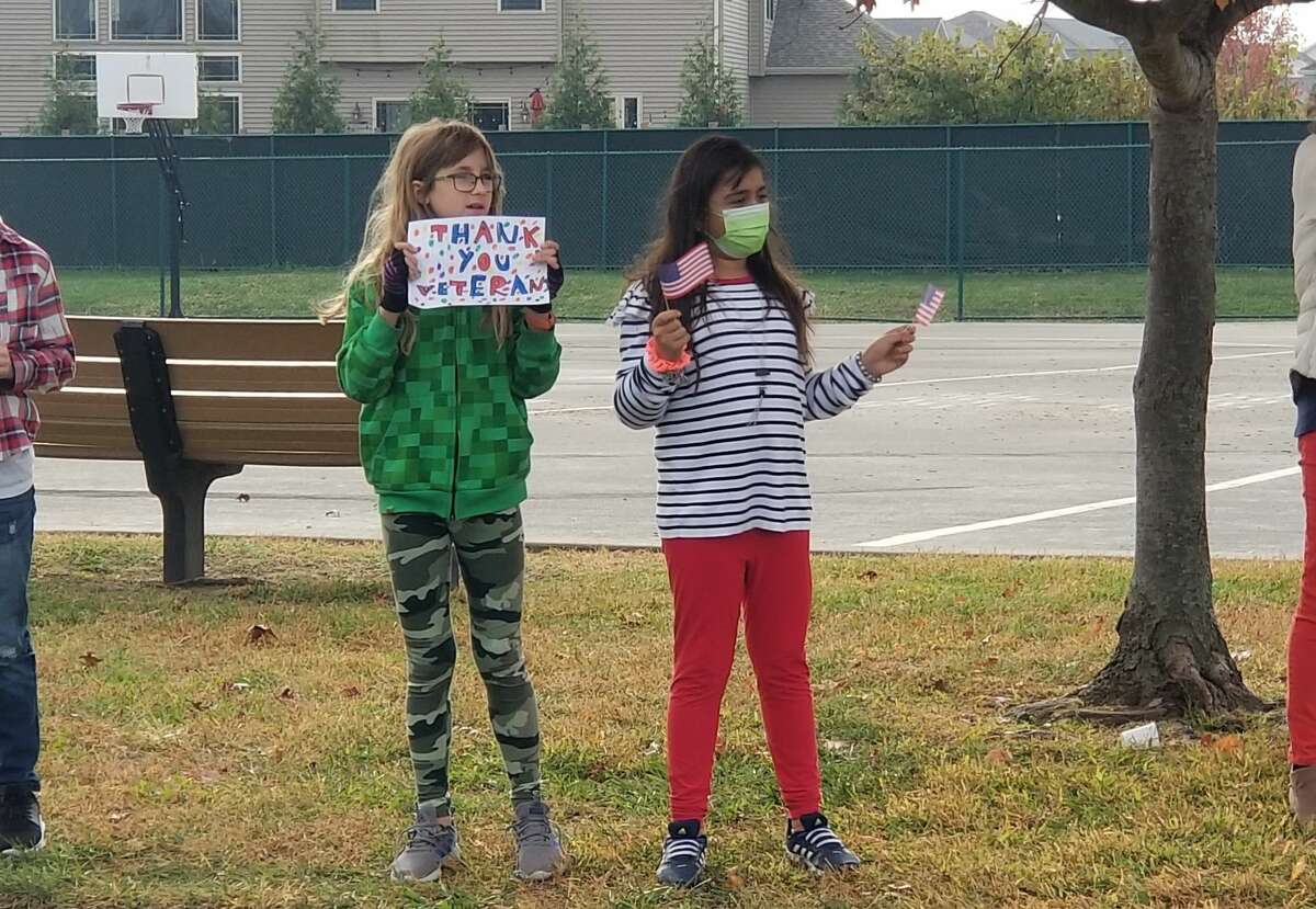 Evelina S. and Zahra J. members of Maggie Clark's 4th grade class were among the many students thanking veterans for their service during Cassens Elementary's Veterans Day parade. 