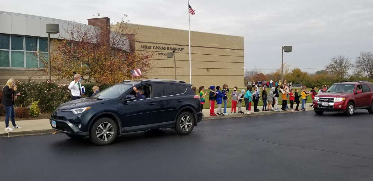 Cassens Elementary School students chanted "Thank you" and "U.S.A" while waving flags for veterans passing by. 