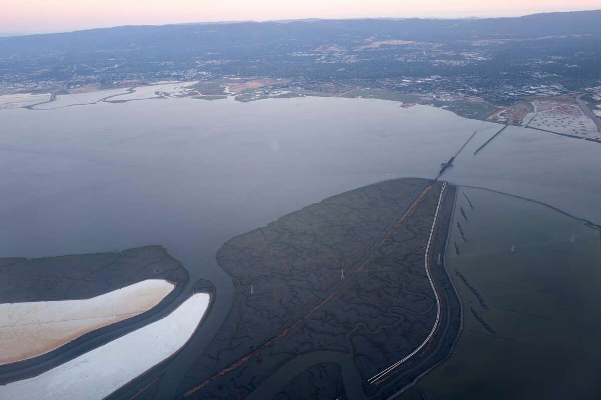 Aerial view of Silicon Valley at dusk, including the Dumbarton Bridge over the San Francisco Bay.