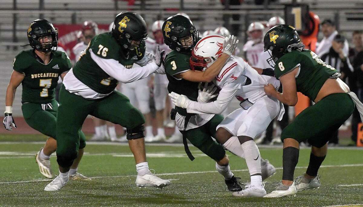 East Chambers' Jesus Matehuala, Wyatt Kash and Cooper McKay contain Darion Hale during their playoff match-up against Huntington Thursday in Lumberton. Photo made Thursday, November 11, 2021 Kim Brent/The Enterprise