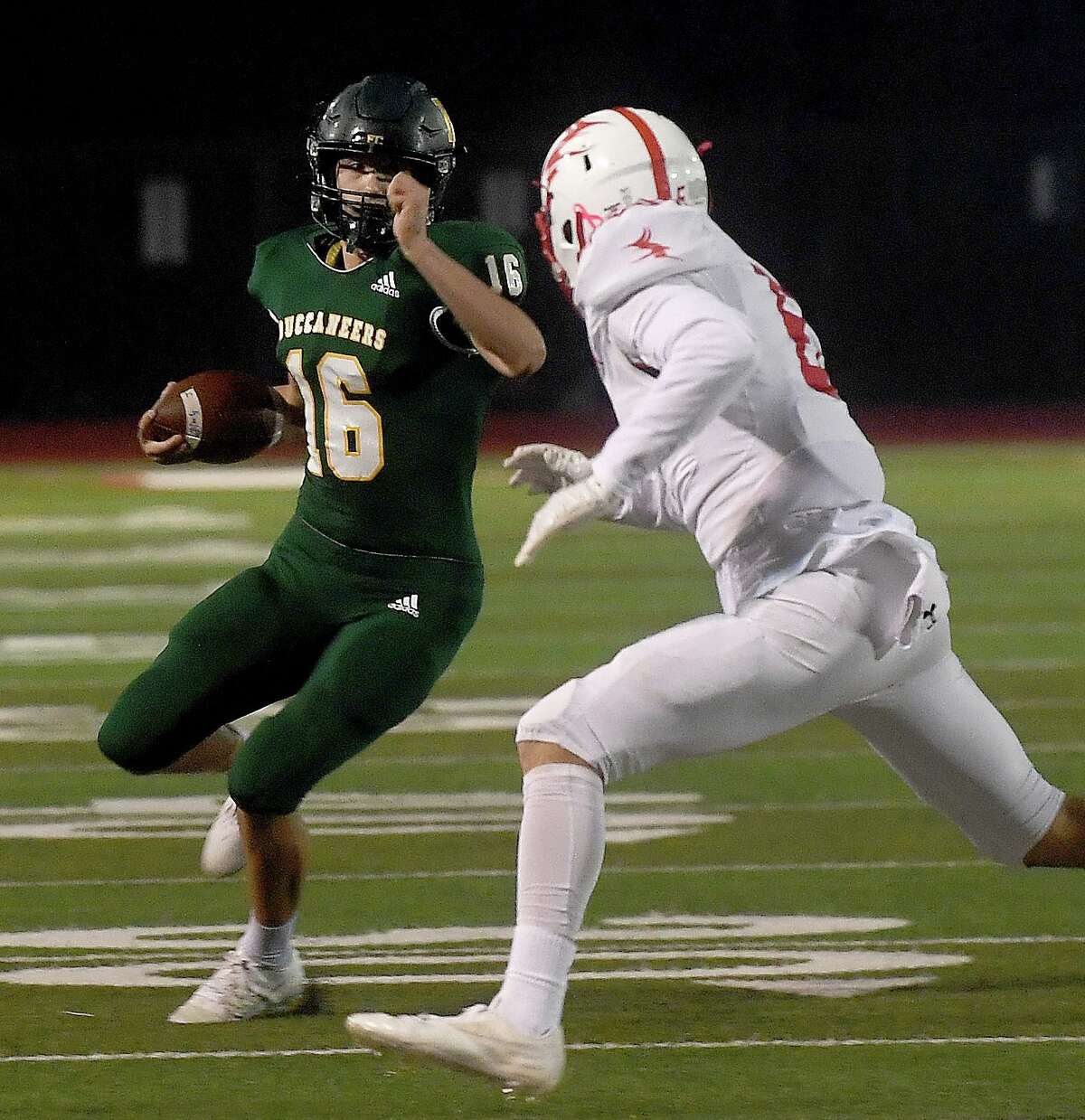 East Chambers' Garrett Reves looks to dodge the defense during their playoff match-up against Huntington Thursday in Lumberton. Photo made Thursday, November 11, 2021 Kim Brent/The Enterprise