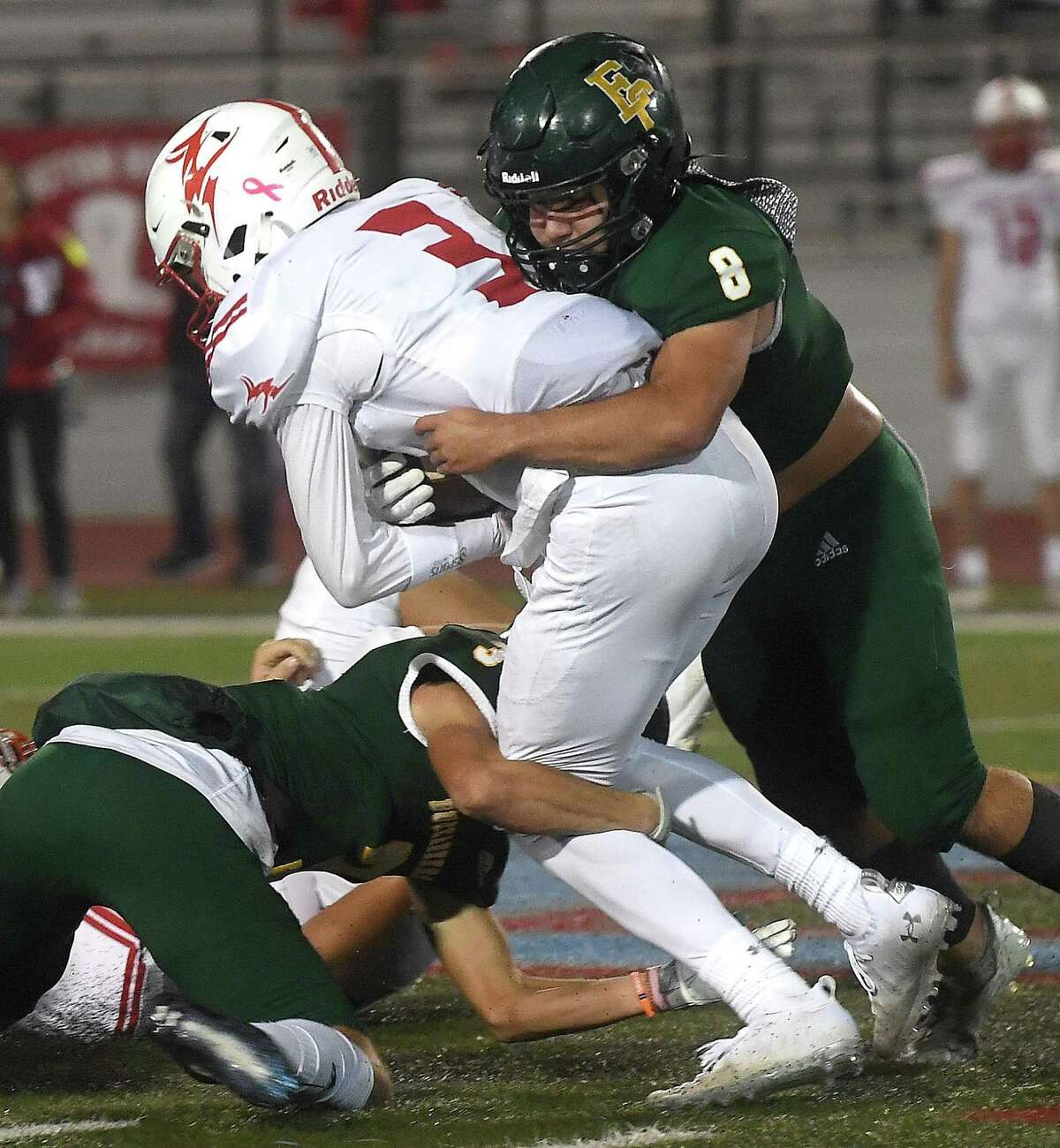 East Chambers' Cooper McKay teams up with the defense to bring down Elijah Mansfield during their playoff match-up against Huntington Thursday in Lumberton. Photo made Thursday, November 11, 2021 Kim Brent/The Enterprise