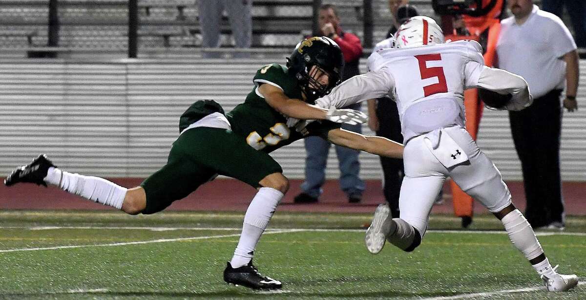 East Chambers' Wyatt Kash dives to try and stop Darion Hale during their playoff match-up against Huntington Thursday in Lumberton. Photo made Thursday, November 11, 2021 Kim Brent/The Enterprise
