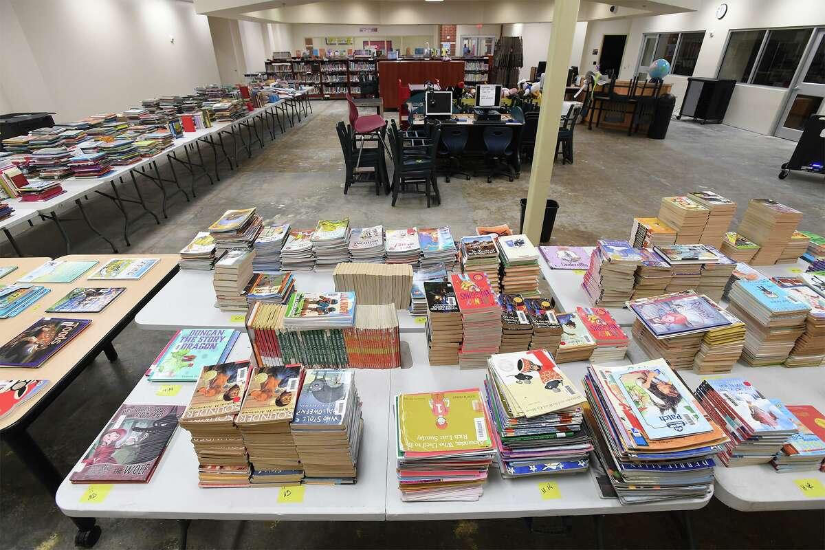 Books in the Fehl-Price Elementary School Library in Beaumont are stacked on tables after a flood in October 2019.
