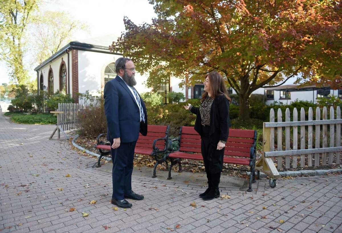 Chabad Lubavitch of Greenwich Executive Director and Spiritual Leader Rabbi Yossi Deren and Educational Director Maryashie Deren speak in the courtyard at Chabad Lubavitch School in Greenwich, Conn. Thursday, Nov. 11, 2021.