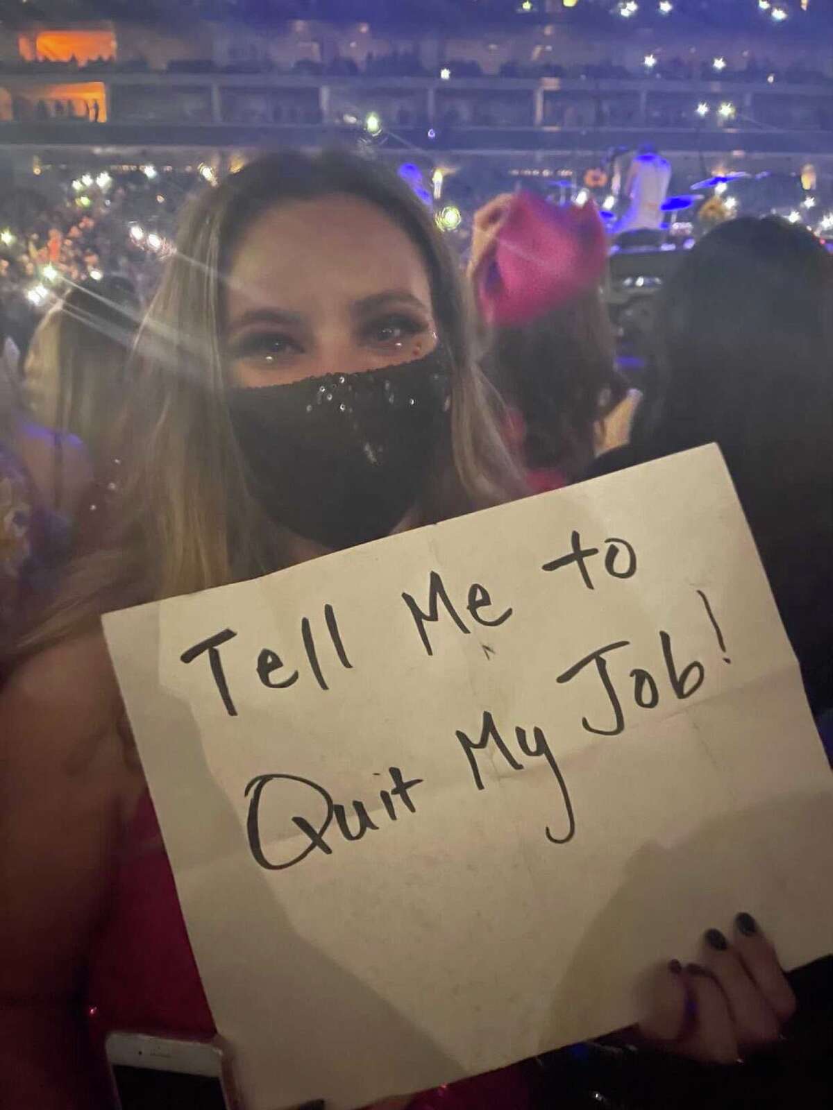 Catherine Dugoni holds her sign at the Harry Styles show.