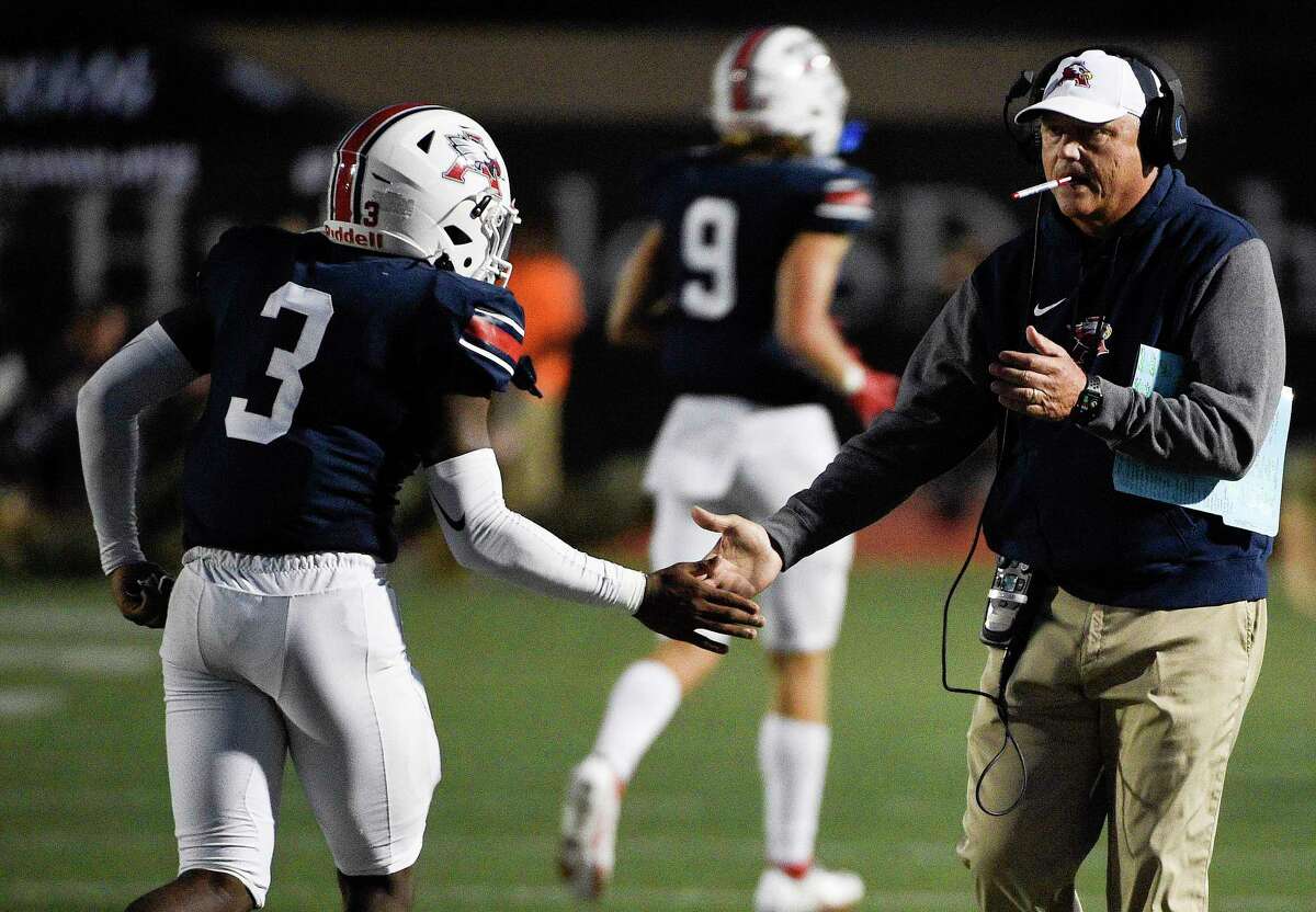 Atascocita head coach Craig Stump, right, celebrates the team’s touchdown with Bennie Qualls (3) during the first half of a high school football game against C.E. King, Saturday, Oct. 16, 2021, in Humble.