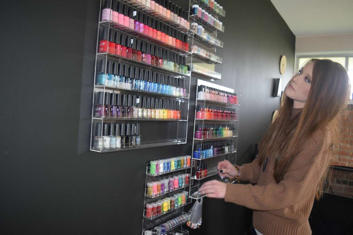 Allison Tucker organizes the supplies Friday in the manicure and pedicure room at Breathe Spa and Wellness Center.