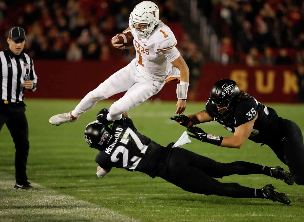 AMES, IA - NOVEMBER 6: Quarterback Hudson Card #1 of the Texas Longhorns is tackled by defensive back Craig McDonald #27, and linebacker Jake Hummel #35 of the Iowa State Cyclones as he scrambled for yards in the first half of play at Jack Trice Stadium on November 6, 2021 in Ames, Iowa. (Photo by David Purdy/Getty Images)