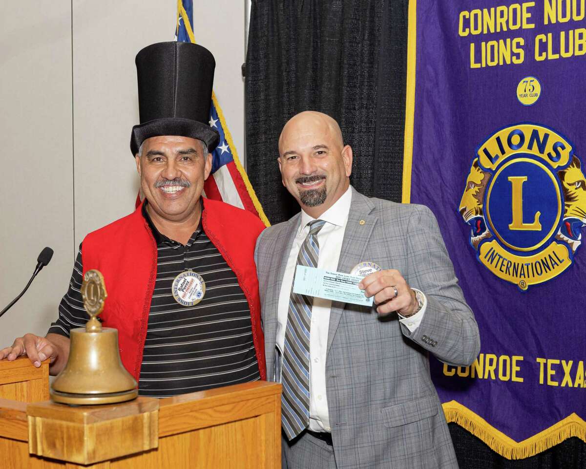 Conroe Noon Lions Club kicked off its annual Lucky Derby Car Raffle recently. As tradition has it, Ringmaster (Chairman) Rafael Perez (l) sells the club President Steve Williams (r) ticket #1.