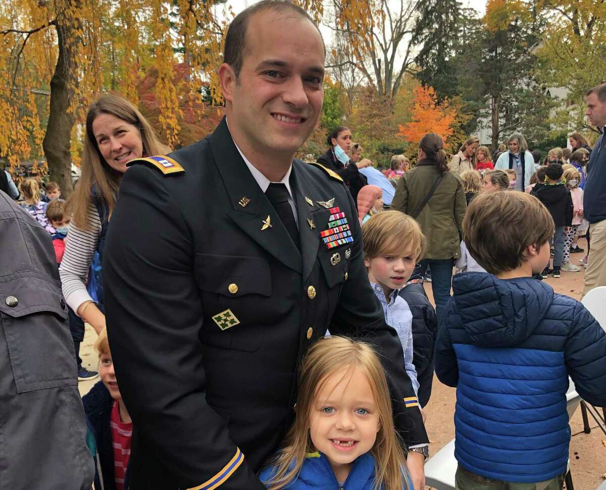 Daniel Izzo, father of Old Greenwich School students Colton, Tanner and Sadie (pictured), is honored at the school's Veterans Day celebration on Thursday. Capt. Izzo is the recipient of the Bronze Star, the Defense Meritorious Service Medal and the U.S. Army Meritorious Service Medal.