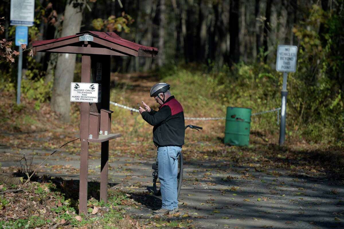 Mike La Gue, of Somers, NY, checks the trail map in Farrington Park. La Gue rode the Maybrook Trailway, in Putnam County, NY, to the park in Danbury, Conn. Wednesday, November 10, 2021, Danbury, Conn.