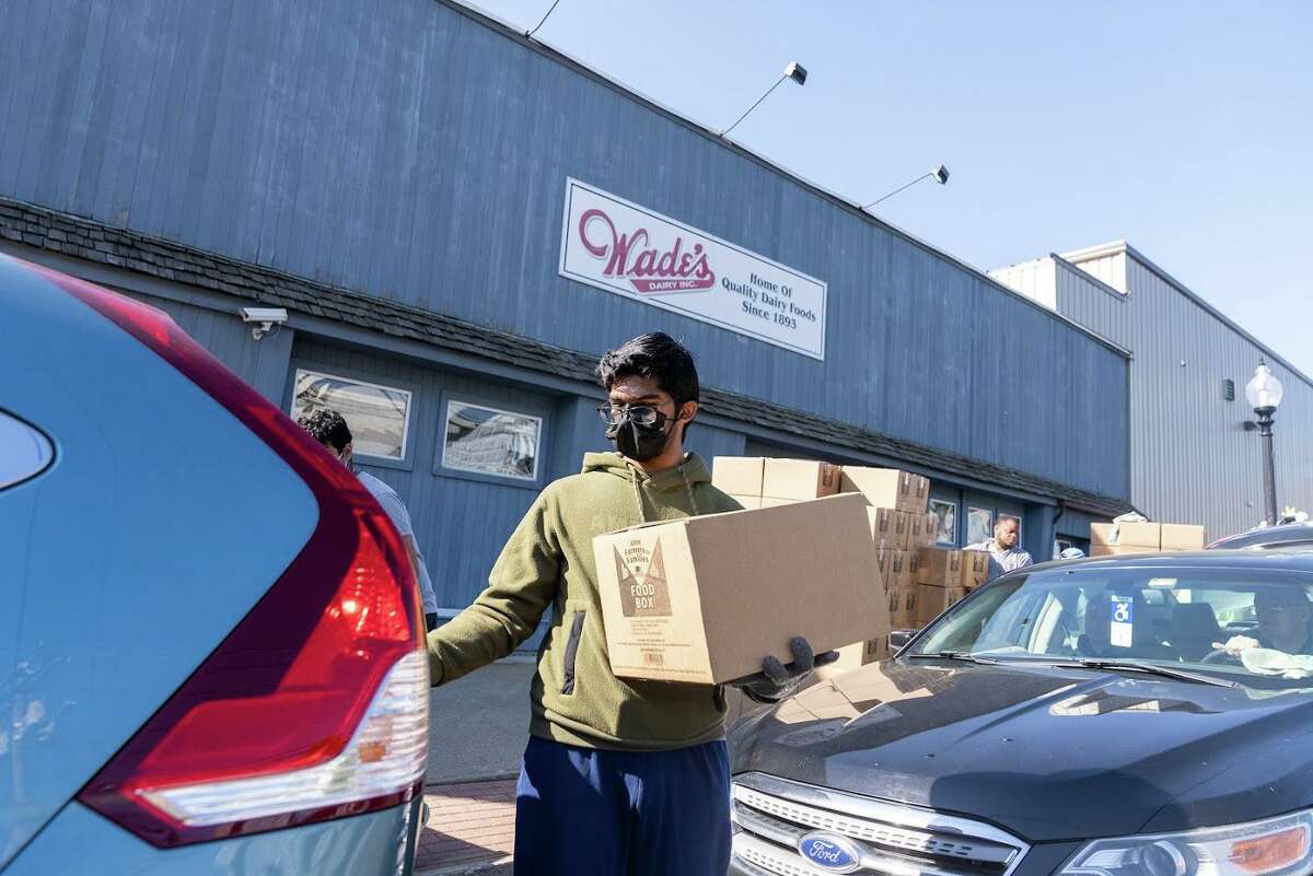 The weekly drive-up food box giveaway at Wade’s Dairy in Bridgeport.